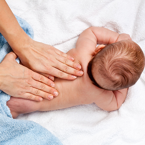 baby receiving a back massage